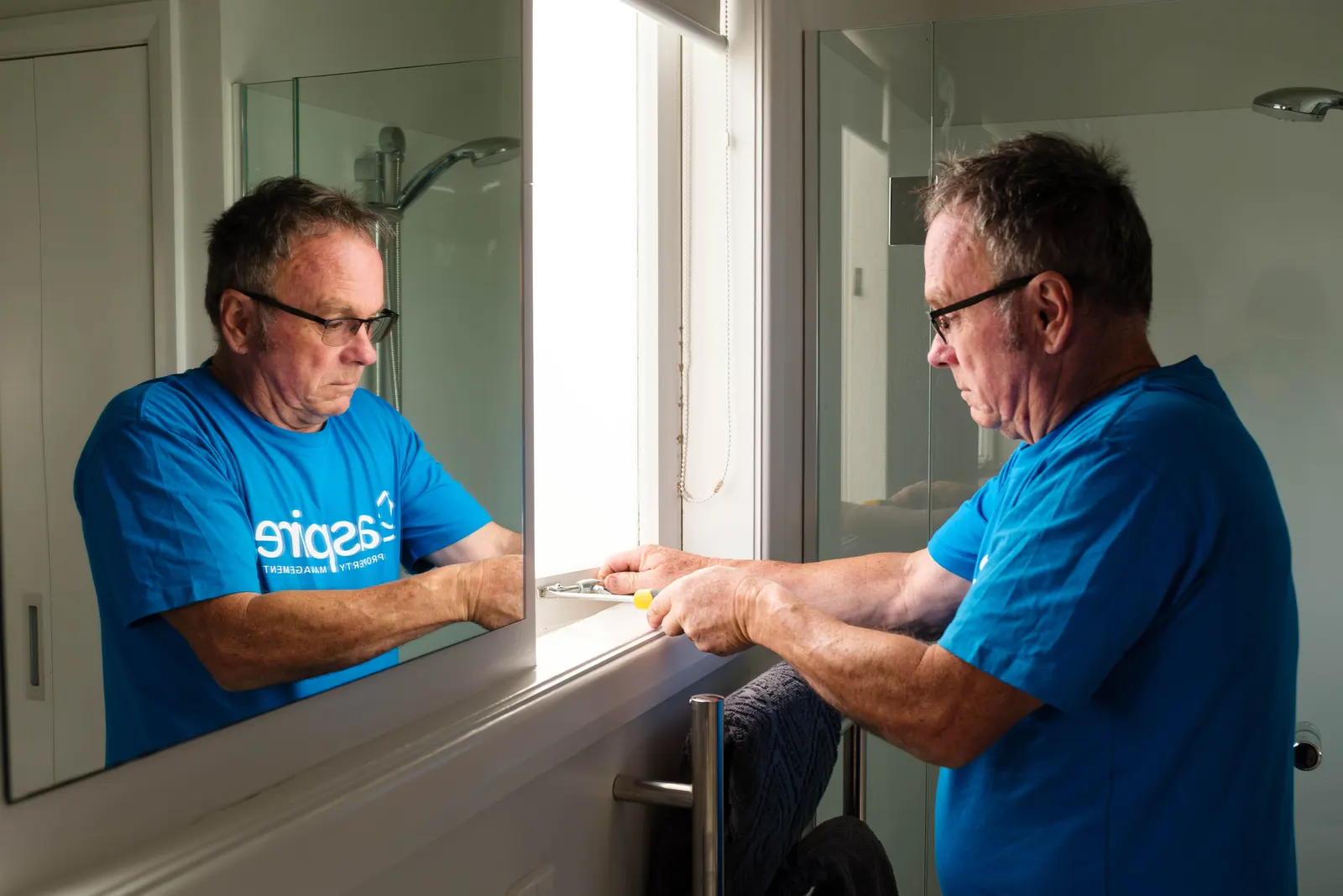Don adjusting a bathroom window latch
